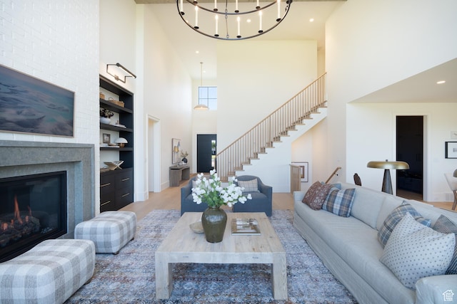 1889 W 1400 S, Lehi, UT 84043 - living area featuring a high ceiling, built in features, stairs, wood finished floors, and a glass covered fireplace