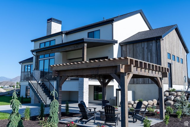 1889 W 1400 S, Lehi, UT 84043 - rear view of property featuring a patio, a chimney, stairs, and an outdoor fire pit