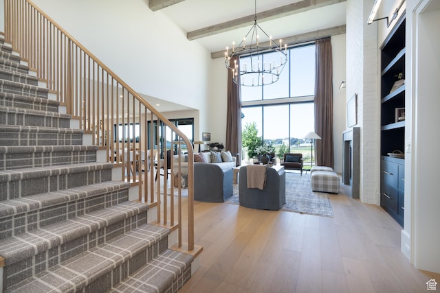 1889 W 1400 S, Lehi, UT 84043 - living area featuring a chandelier, a towering ceiling, light wood-style flooring, stairs, and beam ceiling