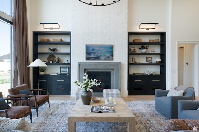 1889 W 1400 S, Lehi, UT 84043 - living room with built in shelves, a glass covered fireplace, and light wood-type flooring