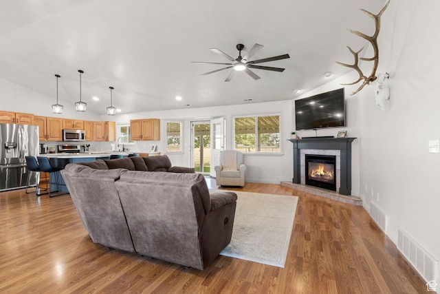 5335 W 5500 S, Hooper, UT 84315 - living area featuring lofted ceiling, ceiling fan, a glass covered fireplace, wood finished floors, and recessed lighting