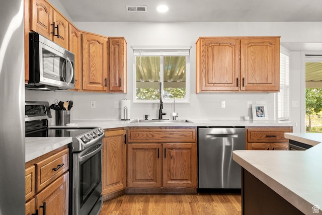 5335 W 5500 S, Hooper, UT 84315 - kitchen with appliances with stainless steel finishes, light countertops, light wood finished floors, recessed lighting, and brown cabinets