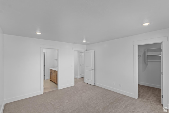 223 E 580 N, Providence, UT 84332 - unfurnished bedroom with light carpet, a walk in closet, recessed lighting, a closet, and ensuite bath
