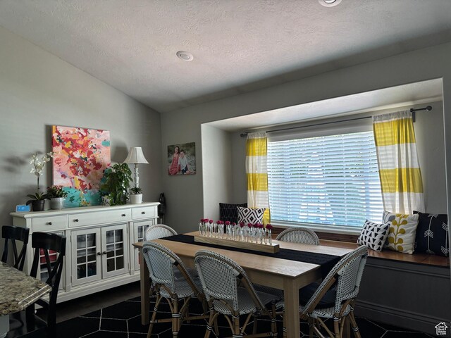 595 E Camden Park Ln, Draper, UT 84020 - dining area featuring vaulted ceiling, a textured ceiling, and dark tile patterned floors