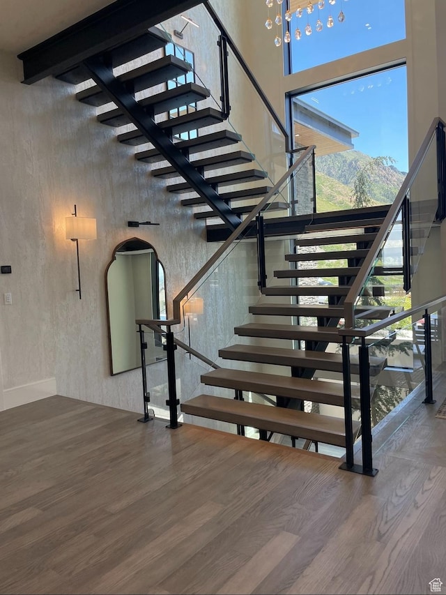 292 N Flag Rock Dr, Farmington, UT 84025 - stairway with a high ceiling, wood finished floors, and arched walkways