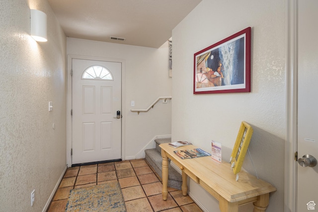 3287 E Fairway Loop, Moab, UT 84532 - doorway featuring stairway, light tile patterned floors, and a textured wall