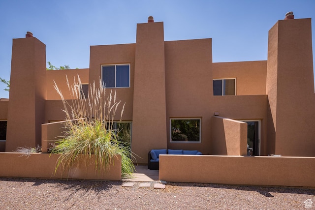 3287 E Fairway Loop, Moab, UT 84532 - rear view of property featuring an outdoor hangout area and stucco siding