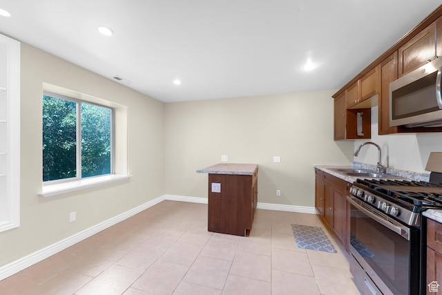 328 S 1060 E, Santaquin, UT 84655 - kitchen with stainless steel appliances, light tile patterned flooring, recessed lighting, light stone counters, and brown cabinets