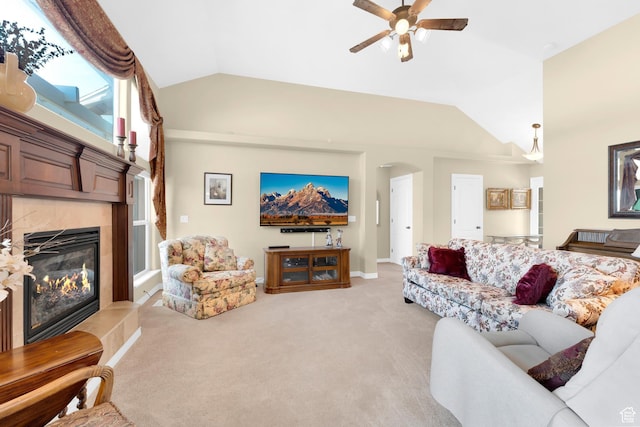 328 S 1060 E, Santaquin, UT 84655 - living room with vaulted ceiling, arched walkways, a ceiling fan, a tiled fireplace, and light colored carpet