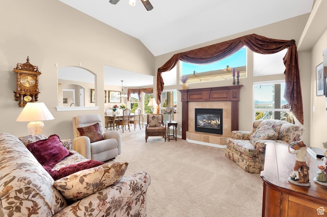 328 S 1060 E, Santaquin, UT 84655 - living area with light carpet, healthy amount of natural light, a ceiling fan, a tile fireplace, and high vaulted ceiling