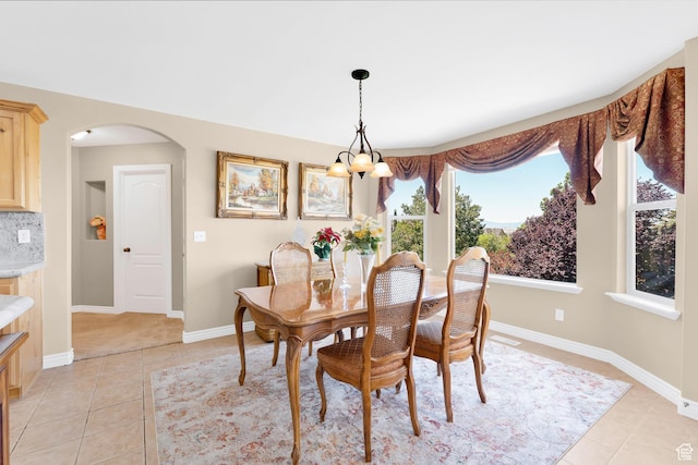 328 S 1060 E, Santaquin, UT 84655 - dining space with light tile patterned flooring, a chandelier, and arched walkways