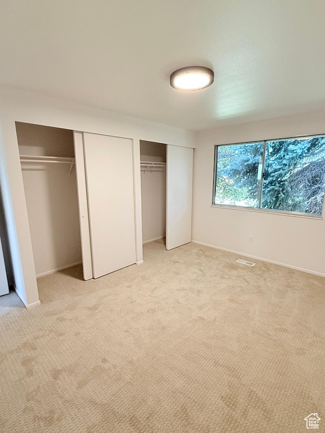 3841 W Bluebird Cir, West Valley City, UT 84120 - unfurnished bedroom with multiple closets and light carpet