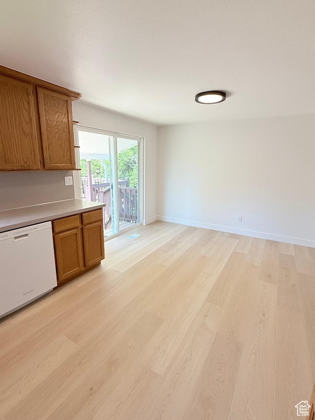 3841 W Bluebird Cir, West Valley City, UT 84120 - kitchen with dishwasher, brown cabinetry, light wood-style flooring, light countertops, and open floor plan