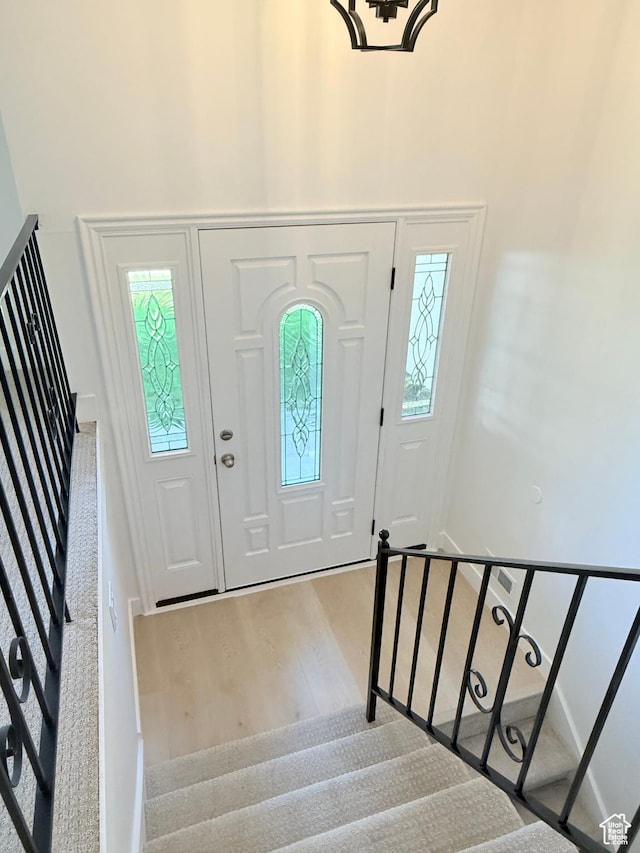 3841 W Bluebird Cir, West Valley City, UT 84120 - entryway featuring stairs, wood finished floors, a high ceiling, and plenty of natural light