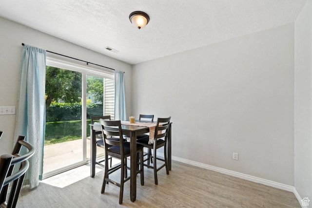 1021 Sara Ln, Ogden, UT 84404 - dining space with wood finished floors and a textured ceiling