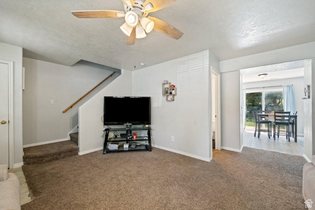 1021 Sara Ln, Ogden, UT 84404 - living area featuring carpet floors, ceiling fan, stairs, and a textured ceiling