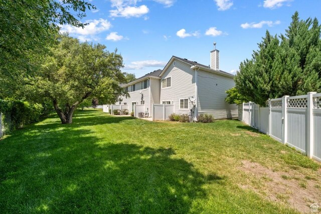 1021 Sara Ln, Ogden, UT 84404 - rear view of property featuring a chimney