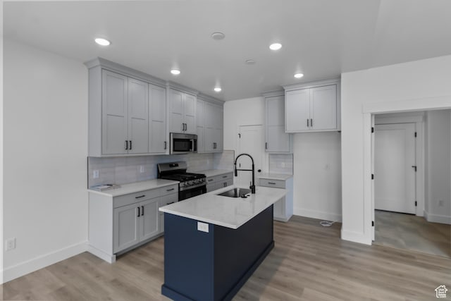 233 E 580 N, Providence, UT 84332 - kitchen featuring stainless steel appliances, backsplash, light countertops, light wood-style flooring, and recessed lighting