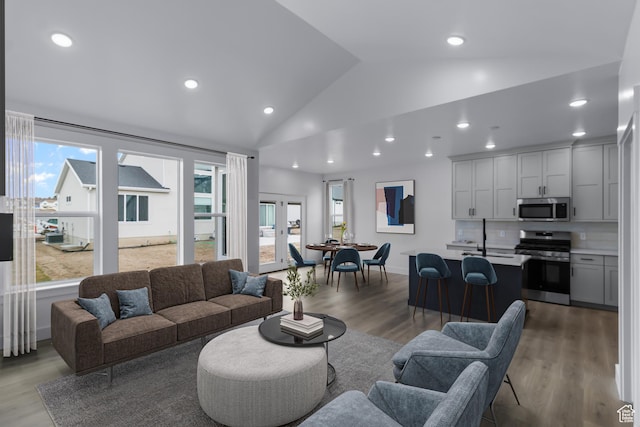 233 E 580 N, Providence, UT 84332 - living room featuring vaulted ceiling, wood finished floors, and recessed lighting