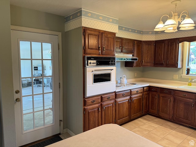1177 W 2060 N, Helper, UT 84526 - kitchen featuring white oven, under cabinet range hood, a chandelier, light countertops, and light tile patterned flooring
