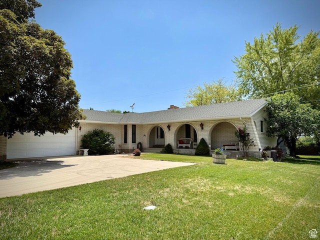 1177 W 2060 N, Helper, UT 84526 - view of front of property with concrete driveway, a front yard, brick siding, a chimney, and an attached garage
