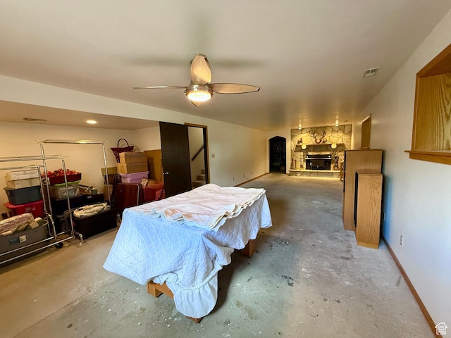 1177 W 2060 N, Helper, UT 84526 - bedroom with unfinished concrete floors, a stone fireplace, and ceiling fan