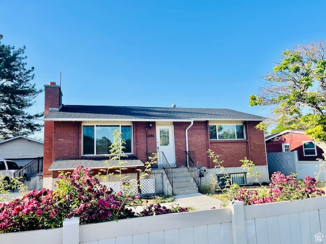 1086 W Wenco Dr S, Salt Lake City, UT 84104 - view of front of property with a chimney, brick siding, and a shingled roof
