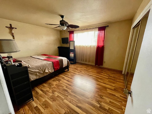 1086 W Wenco Dr S, Salt Lake City, UT 84104 - bedroom with wood finished floors, ceiling fan, a closet, and a textured ceiling