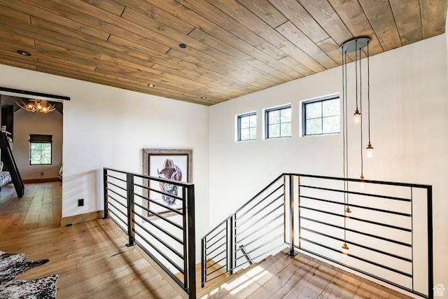 1766 W Arapaho Dr, Wanship, UT 84017 - stairway with wooden ceiling, hardwood / wood-style floors, plenty of natural light, and a chandelier