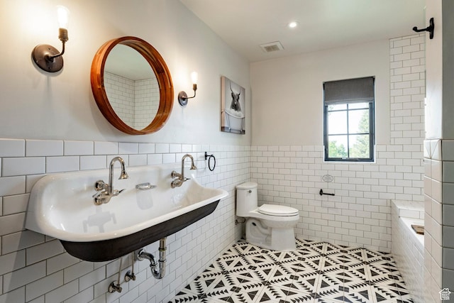 1766 W Arapaho Dr, Wanship, UT 84017 - bathroom featuring tile walls, tile patterned floors, wainscoting, and a tub to relax in