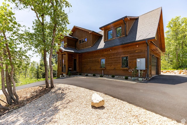 1766 W Arapaho Dr, Wanship, UT 84017 - view of front of home featuring driveway, a garage, and a shingled roof