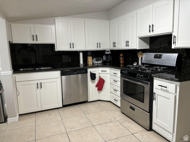 783 W 400 S, Orem, UT 84058 - kitchen featuring stainless steel appliances, vaulted ceiling, decorative backsplash, white cabinetry, and light tile patterned flooring