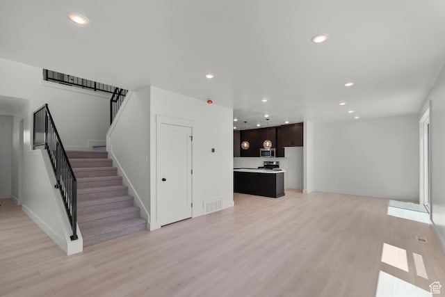 216 E 610 N, Providence, UT 84332 - unfurnished living room with stairway, light wood-type flooring, and recessed lighting