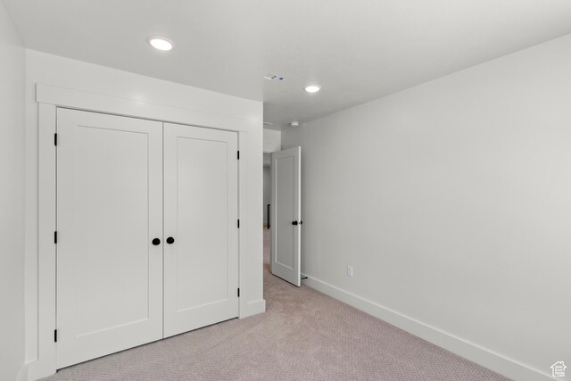 216 E 610 N, Providence, UT 84332 - unfurnished bedroom featuring light colored carpet, recessed lighting, and a closet