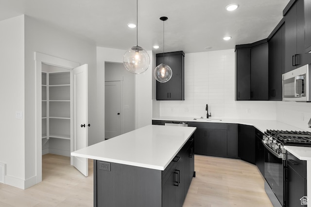 216 E 610 N, Providence, UT 84332 - kitchen featuring appliances with stainless steel finishes, dark cabinetry, light wood-style floors, and recessed lighting