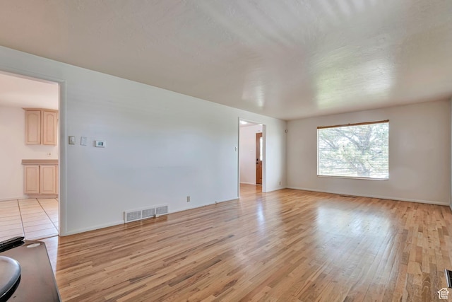 4683 W 3855 S, West Valley City, UT 84120 - unfurnished living room with light wood finished floors and baseboards