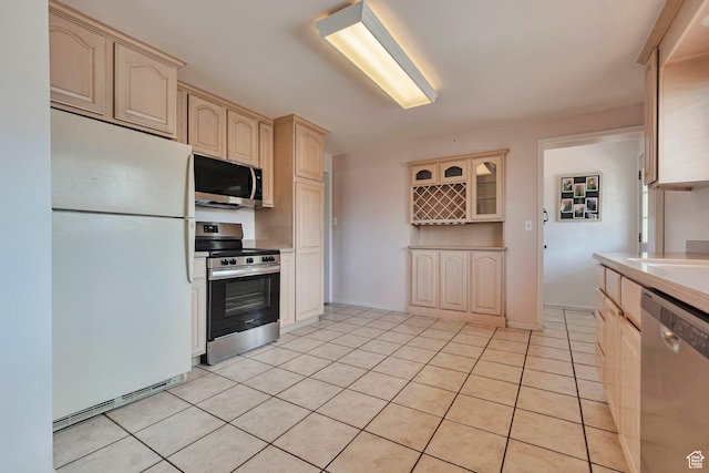 4683 W 3855 S, West Valley City, UT 84120 - kitchen featuring appliances with stainless steel finishes, light tile patterned floors, light brown cabinets, and light countertops