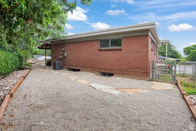 1881 S Foothill Dr E, Salt Lake City, UT 84108 - view of property exterior with brick siding and a central AC unit