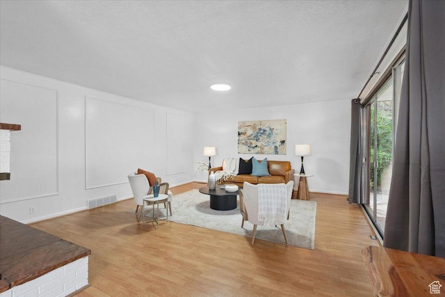 1881 S Foothill Dr E, Salt Lake City, UT 84108 - living room featuring wood finished floors and a decorative wall