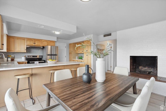 1881 S Foothill Dr E, Salt Lake City, UT 84108 - dining room with light tile patterned floors and a fireplace