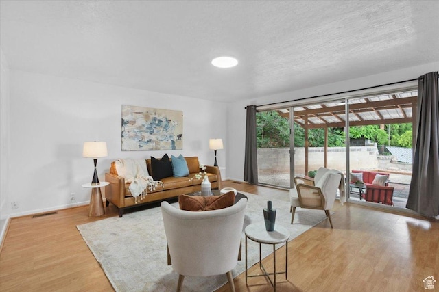 1881 S Foothill Dr E, Salt Lake City, UT 84108 - living area featuring wood finished floors and a textured ceiling