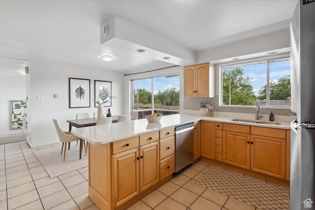 1881 S Foothill Dr E, Salt Lake City, UT 84108 - kitchen featuring stainless steel appliances, light tile patterned flooring, light countertops, and a peninsula