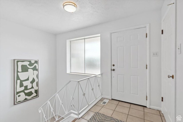 1881 S Foothill Dr E, Salt Lake City, UT 84108 - foyer with light tile patterned flooring and a textured ceiling