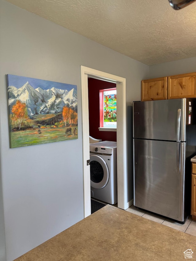 471 N 100 W, Kamas, UT 84036 - washroom featuring washer / clothes dryer, light tile patterned floors, and a textured ceiling