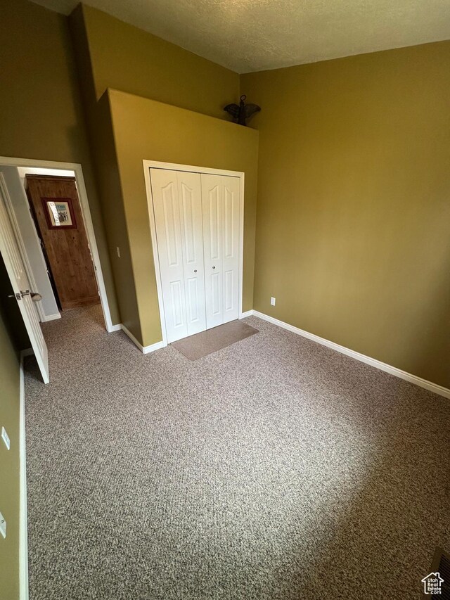 471 N 100 W, Kamas, UT 84036 - unfurnished bedroom featuring a closet, carpet flooring, and a textured ceiling