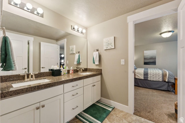 5673 S Wilson View Ct, Holladay, UT 84121 - bathroom featuring double vanity, ensuite bathroom, and a textured ceiling