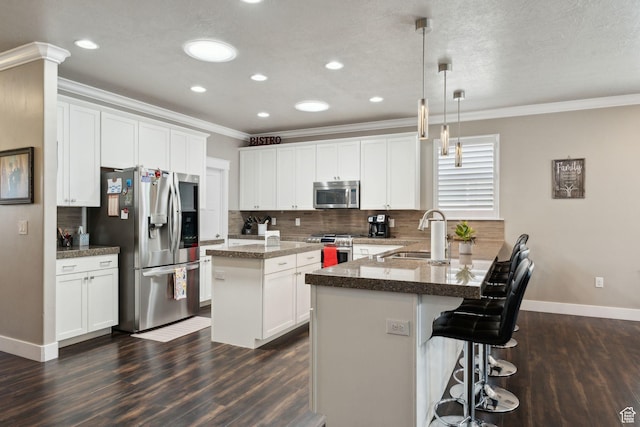 5673 S Wilson View Ct, Holladay, UT 84121 - kitchen with stainless steel appliances, ornamental molding, dark wood-style flooring, a peninsula, and backsplash