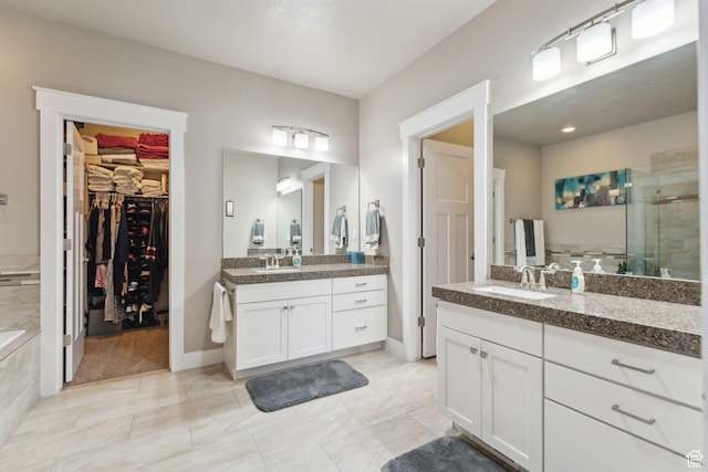 5673 S Wilson View Ct, Holladay, UT 84121 - full bath featuring a stall shower, two vanities, a spacious closet, and a tub to relax in