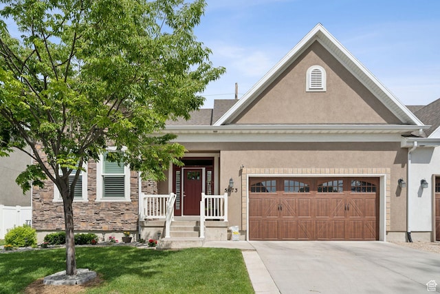 5673 S Wilson View Ct, Holladay, UT 84121 - view of front of property with stucco siding, concrete driveway, a front yard, a garage, and stone siding