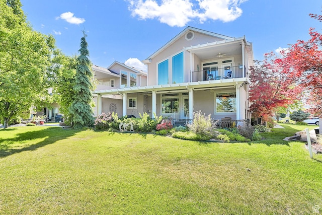 97 Hillsborough Dr, Pleasant View, UT 84414 - view of front of property with a balcony, a ceiling fan, stucco siding, and a front yard